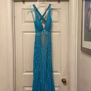 Beautiful aqua floor length gown with silver jewel detail.